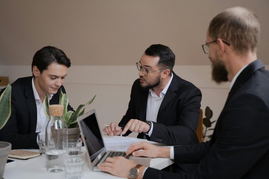 Three people in the middle of a customer acquisition meeting.