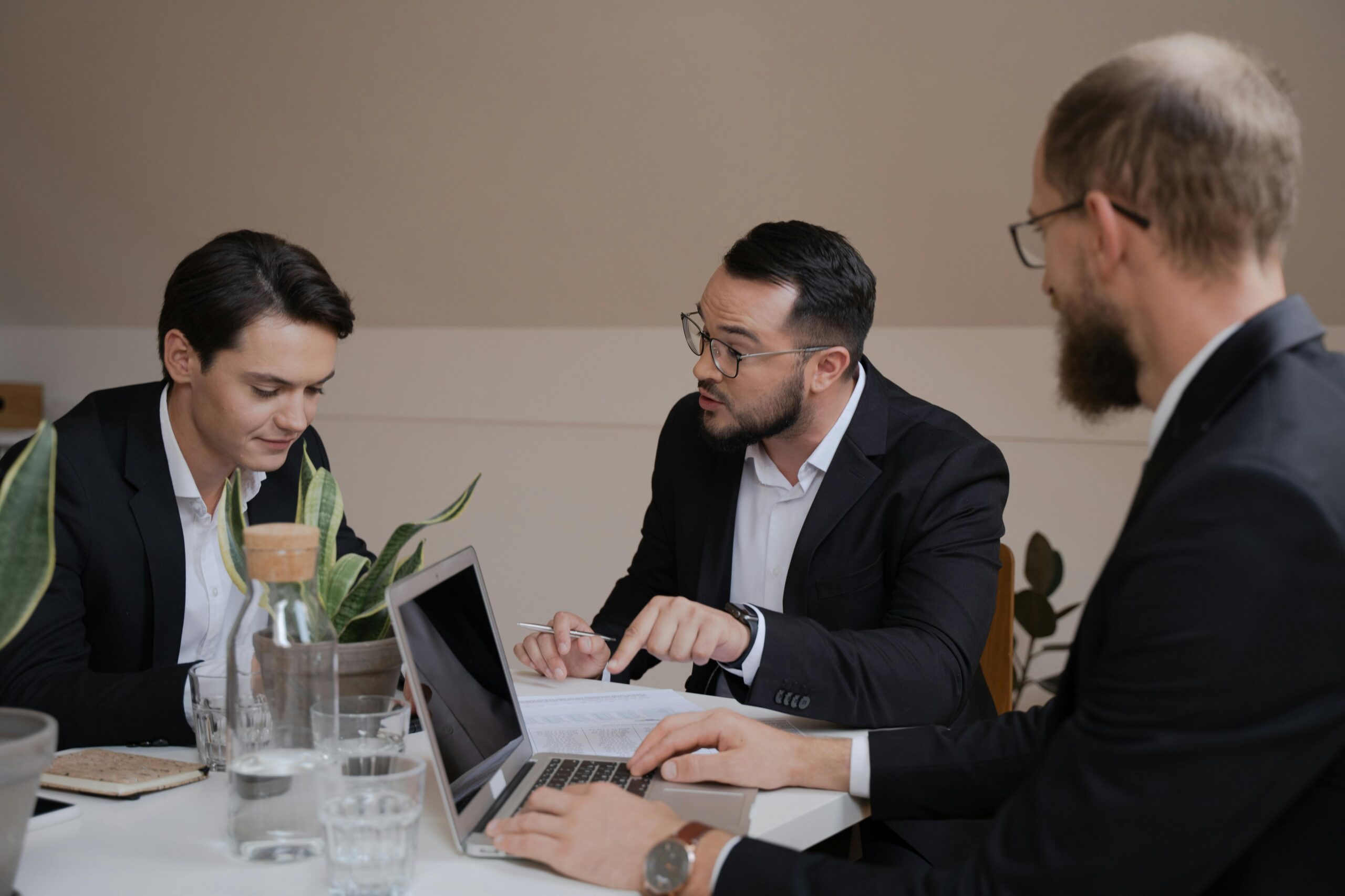 Three people in the middle of a customer acquisition meeting.